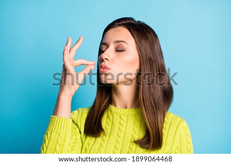 Photo of young attractive woman show gesture perfect tasty sign enjoy meal isolated over blue color background