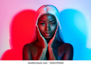 Photo of young beautiful stunning african woman touching cheeks wear artificial wig isolated on vivid colorful background