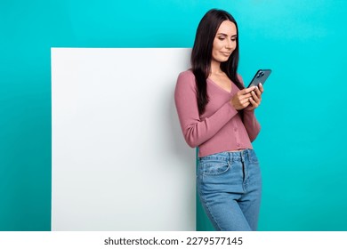 Photo of young beautiful woman smart casual outfit hold phone reading online ebook billboard paper empty space isolated on cyan color background - Shutterstock ID 2279577145