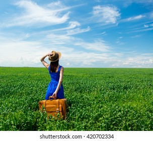 photo of young beautiful woman with suitcase in the field - Shutterstock ID 420702334