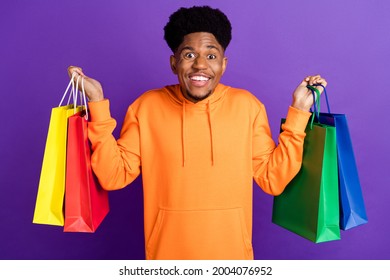 Photo Of Young Black Man Happy Positive Smile Hold Shopping Bags Black Friday Customer Isolated Over Violet Color Background