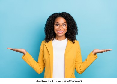 Photo of young black woman happy positive smile hold hands product promo ads isolated over blue color background - Shutterstock ID 2069579660