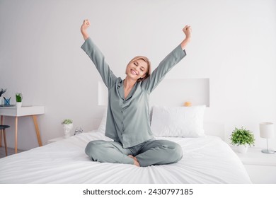 Photo of young blonde sweet adorable lady grey sleepwear chill in apartment raised fists waking up at hotel bedroom white light interior - Powered by Shutterstock