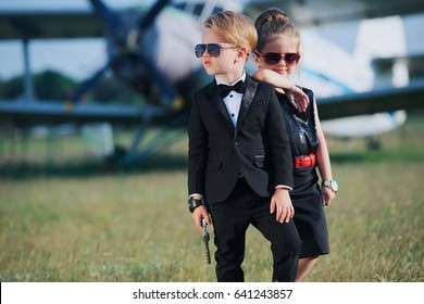 photo of young boy and girl playing spy