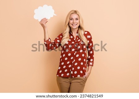 Photo of young business lady hold paper cloud idea make decision smart solution wear dotted red shirt isolated on beige color background