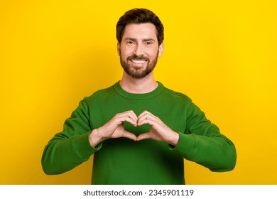 Photo of young businessman gesture fingers heart symbol sympathy for his girlfriend support beginnings isolated on yellow color background