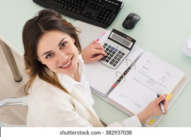 Photo Of Young Businesswoman Calculating Invoice In Office - Powered by Shutterstock