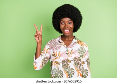 Photo Of Young Cheerful Afro Girl Happy Positive Smile Show Peace Cool V-sign Isolated Over Green Color Background