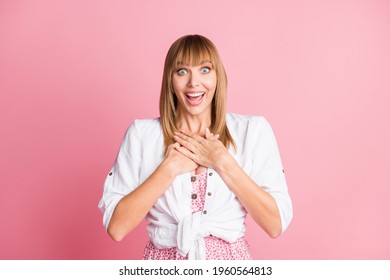 Photo of young cheerful attractive woman happy positive smile hands on chest surprised grateful isolated over pink color background