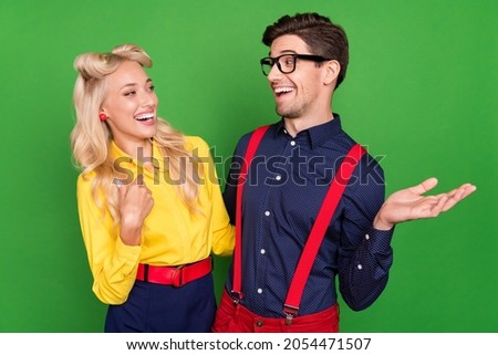 Photo of young cheerful couple have fun laugh humor joke event party isolated over green color background