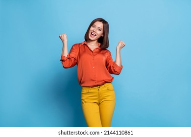 Photo of young cheerful excited girl rejoice success fist hands awesome isolated over blue color background - Shutterstock ID 2144110861