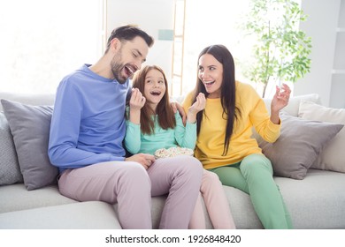 Photo Of Young Cheerful Family Mom Dad Daughter Happy Positive Smile Sit Couch Have Fun Eat Popcorn Home