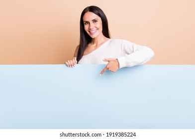 Photo Of Young Cheerful Girl Happy Smile Point Finger Empty Space Poster Ad Promo Offer Isolated Over Beige Color Background