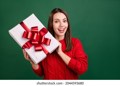 Photo of young cheerful girl happy positive smile receive gift new year winter isolated over green color background