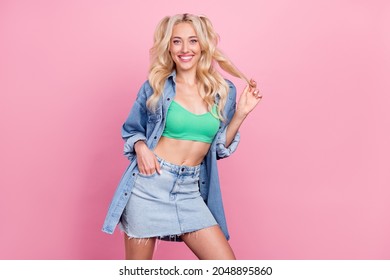 Photo of young cheerful girl happy positive smile wear denim mini skirt summer isolated over pink color background