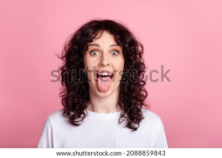 Photo of young cheerful girl have fun stick-out fool grimace pet isolated over pink color background