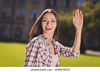 Photo Of Young Cheerful Girl Student Happy Positive Smile Look Empty Space Wave Hand Hello Outside Park