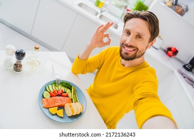 Photo of young cheerful guy shooting selfie show fingers okey symbol rate feedback perfect ideal meal indoors - Powered by Shutterstock