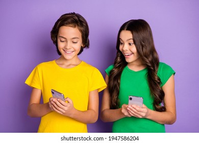 Photo Of Young Cheerful Kids Happy Positive Smile Boy Show Girl Post Comment Cellphone Isolated Over Violet Color Background