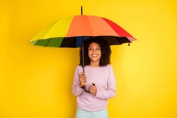 Photo Of Young Cheerful Lady Hold Umbrella Rainy Weather Spring Isolated Over Yellow Color Background.
