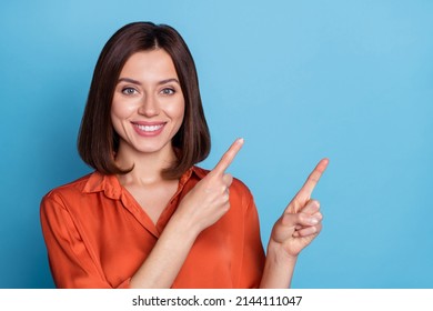 Photo of young cheerful lady indicate fingers empty space ads promo proposition isolated over blue color background - Shutterstock ID 2144111047