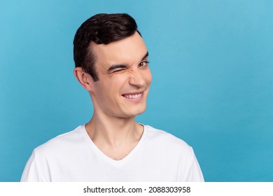 Photo Of Young Cheerful Man Good Mood Wink Eye Flirty Date Romance Isolated Over Blue Color Background