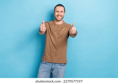 Photo of young cheerful positive happy advertiser wear brown t-shirt thumbs up agreement enjoy candidate job isolated on blue color background - Shutterstock ID 2279577197