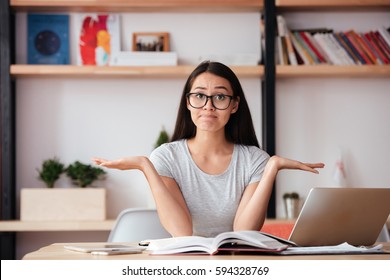Photo of young confused woman indoors reading magazine. Coworking concept. - Shutterstock ID 594328769