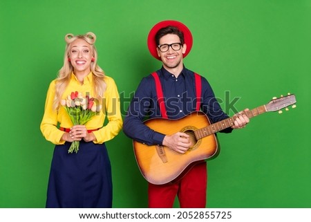 Photo of young couple date romantic play guitar tulips feelings dream story isolated over green color background