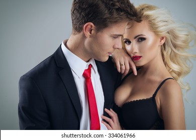 Photo Of A Young Couple In Sensual Lingerie And Suit
