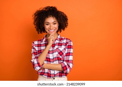 Photo of young curly lady hand face wear plaid shirt isolated on orange color background