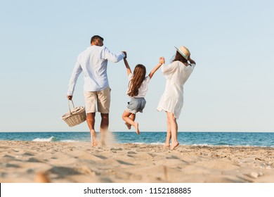 Photo Of Young Cute Happy Family Having Fun Together At The Beach.