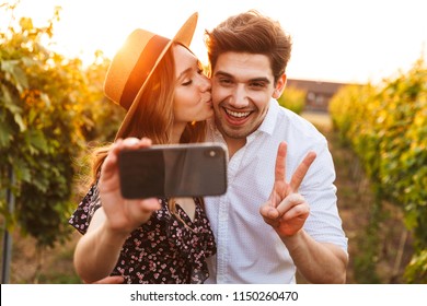 Photo of young cute happy loving couple outdoors take a selfie by mobile phone. - Powered by Shutterstock