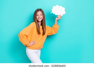 Photo of young cute little girl touch waist hold paper bubble cloud chatterbox talking phrase smiling isolated on aquamarine color background