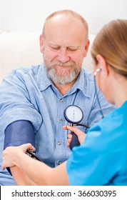 Photo of young doctor measures the blood pressure