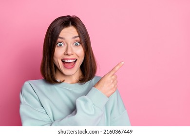 Photo Of Young Excited Girl Indicate Finger Empty Space Proposition Promo Select Discount Isolated Over Pink Color Background