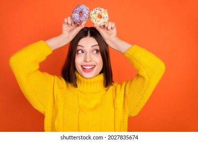 Photo of young excited woman happy positive smile cookies ears playful look empty space isolated over orange color background