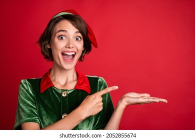 Photo of young excited woman happy positive smile indicate finger ads offer sale season winter isolated over red color background