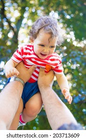 Photo Of A Young Family At Play In A Neighborhood Park