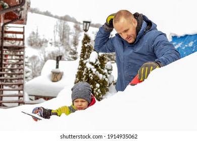 Photo Of A Young Father And Child Brushing And Shoveling Snow And Ice Off Car After Heavy Storm. Single Parent And Kid With Winter Scraper Clearing Family Car After Overnight Snow Blizzard. 