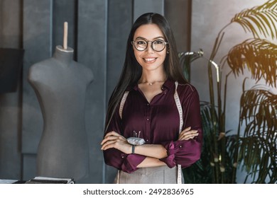 Photo of young female fashion designer standing in design studio. Asian woman and designer portrait of clothing tailor with business vision. Fashion industry, small business, startup concept - Powered by Shutterstock