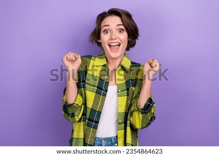 Photo of young funky woman raised fists up hooray celebration big sale promo advert shopping promo isolated on violet color background