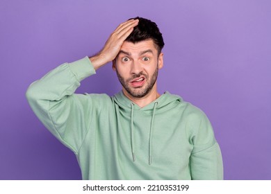 Photo Of Young Funny Excited Nervous Unhappy Man Wear Khaki Hoodie Touch His Head Forget Oops House Keys Grimace Isolated On Violet Color Background