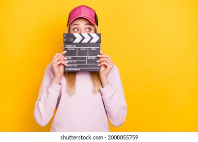 Photo Of Young Girl Close Cover Mouth Clapperboard Scene Film Maker Cinematography Isolated Over Yellow Color Background