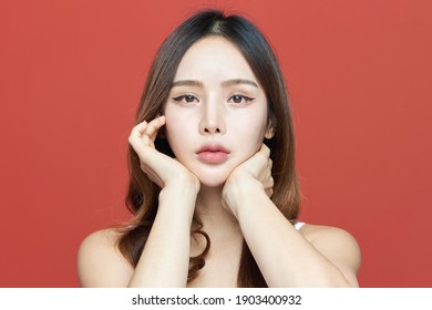 Photo of young girl with flawless skin on Red background. Skin care and beauty concept