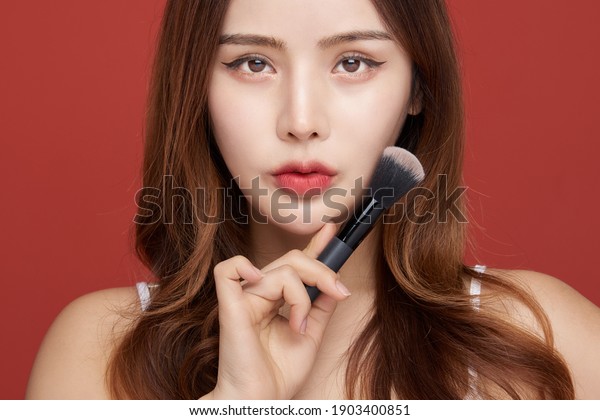 Photo of young girl with flawless skin on\
Red background. Skin care and beauty\
concept