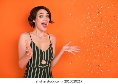 Photo Of Young Girl Happy Positive Smile Amazed Shocked Surprise Air Fly Confetti Party Isolated Over Orange Color Background