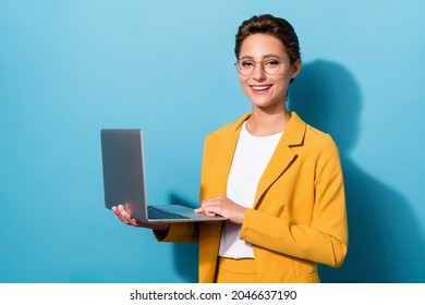 Photo of young girl happy positive smile work laptop programmer confident isolated over blue color background
