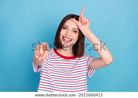 Photo of young girl happy positive smile point finger you bully abuse mocking loser isolated over blue color background