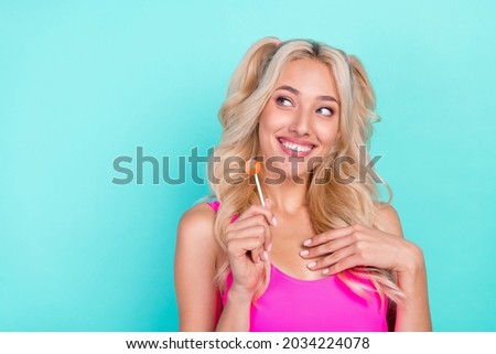 Photo of young girl happy positive smile dream eat lollypop candy sweet dessert isolated over teal color background